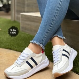 Zapatillas en cuero para mujer con suela deportiva y detalles en gamuza. Cómodas, modernas y perfectas para uso diario.